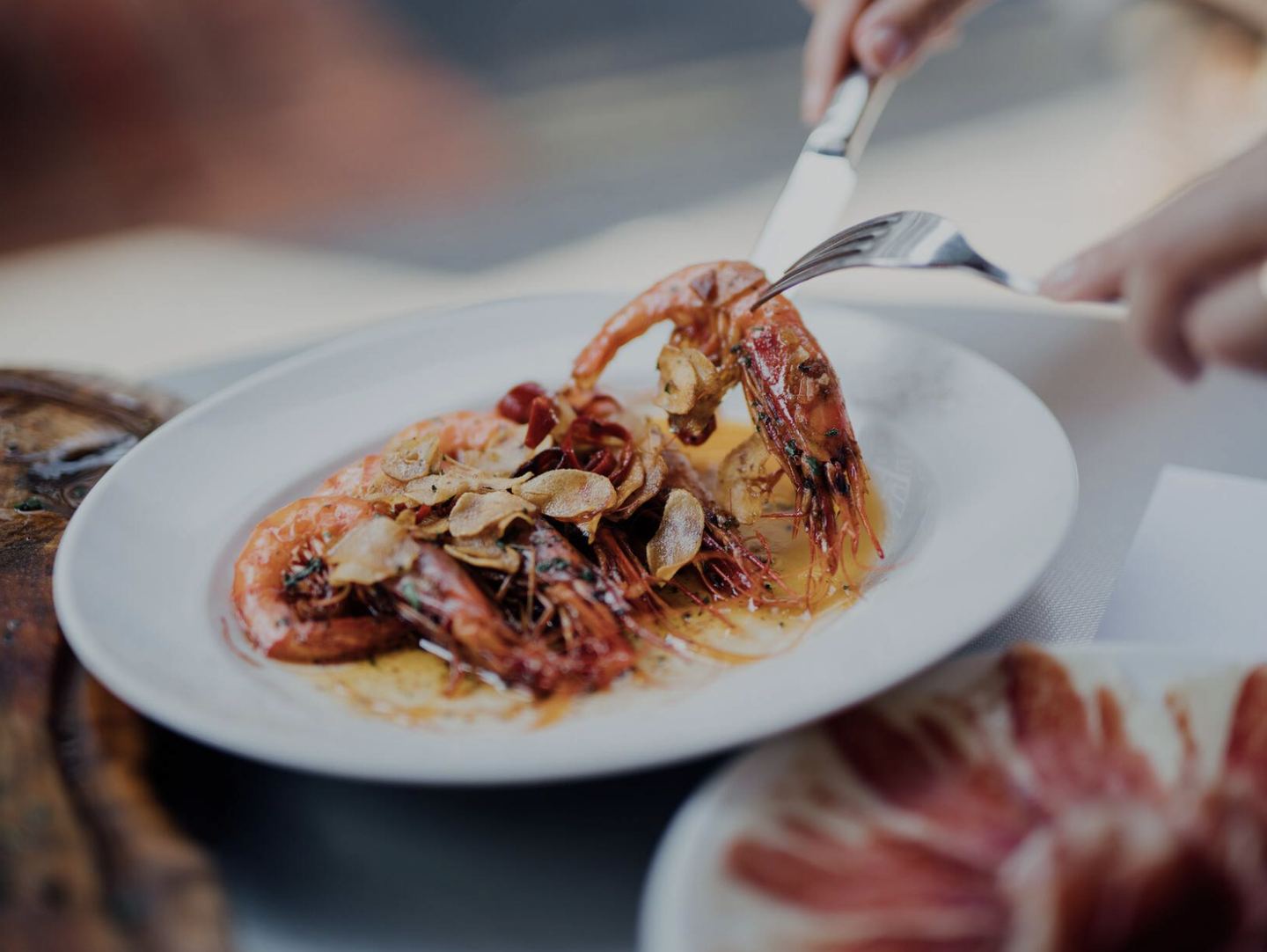 Grilled prawns with garlic served on a white plate