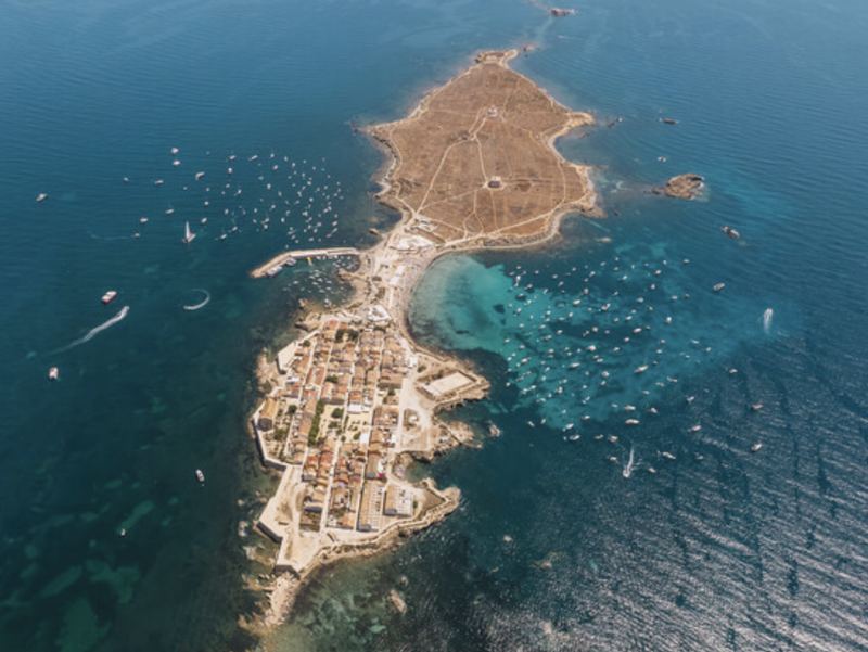 Aerial view of Tabarca island and its walled village, surrounded by boats