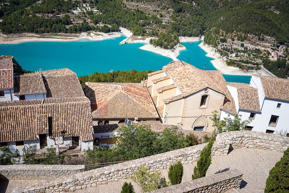 The village of Guadalest with its church and the turquoise reservoir below